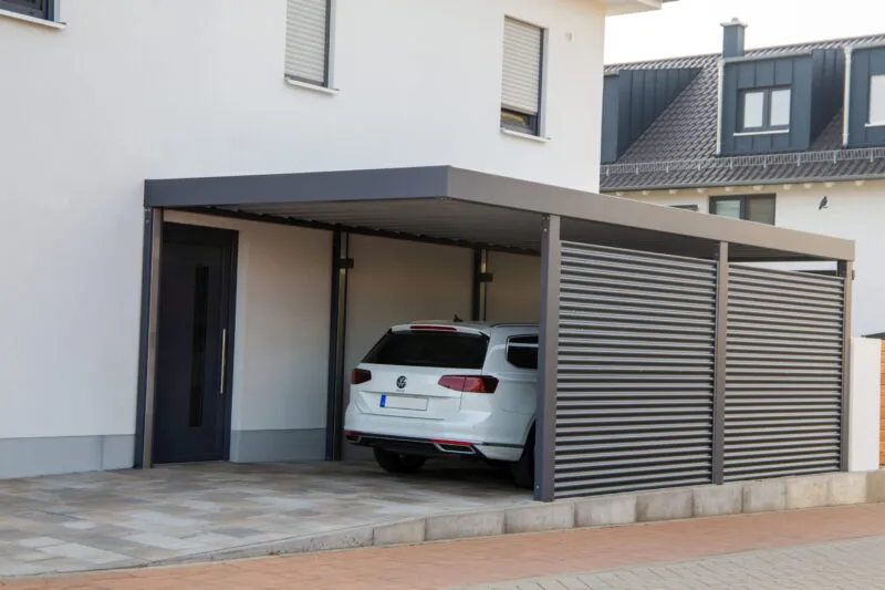 Modern aluminium carport with a VW Golf GTE parked in it (Rhineland Palatinate, Germany, October 10, 2023)